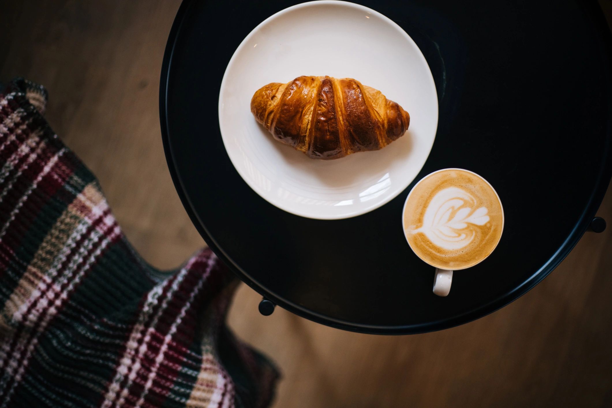 Coffee and croissant on a table