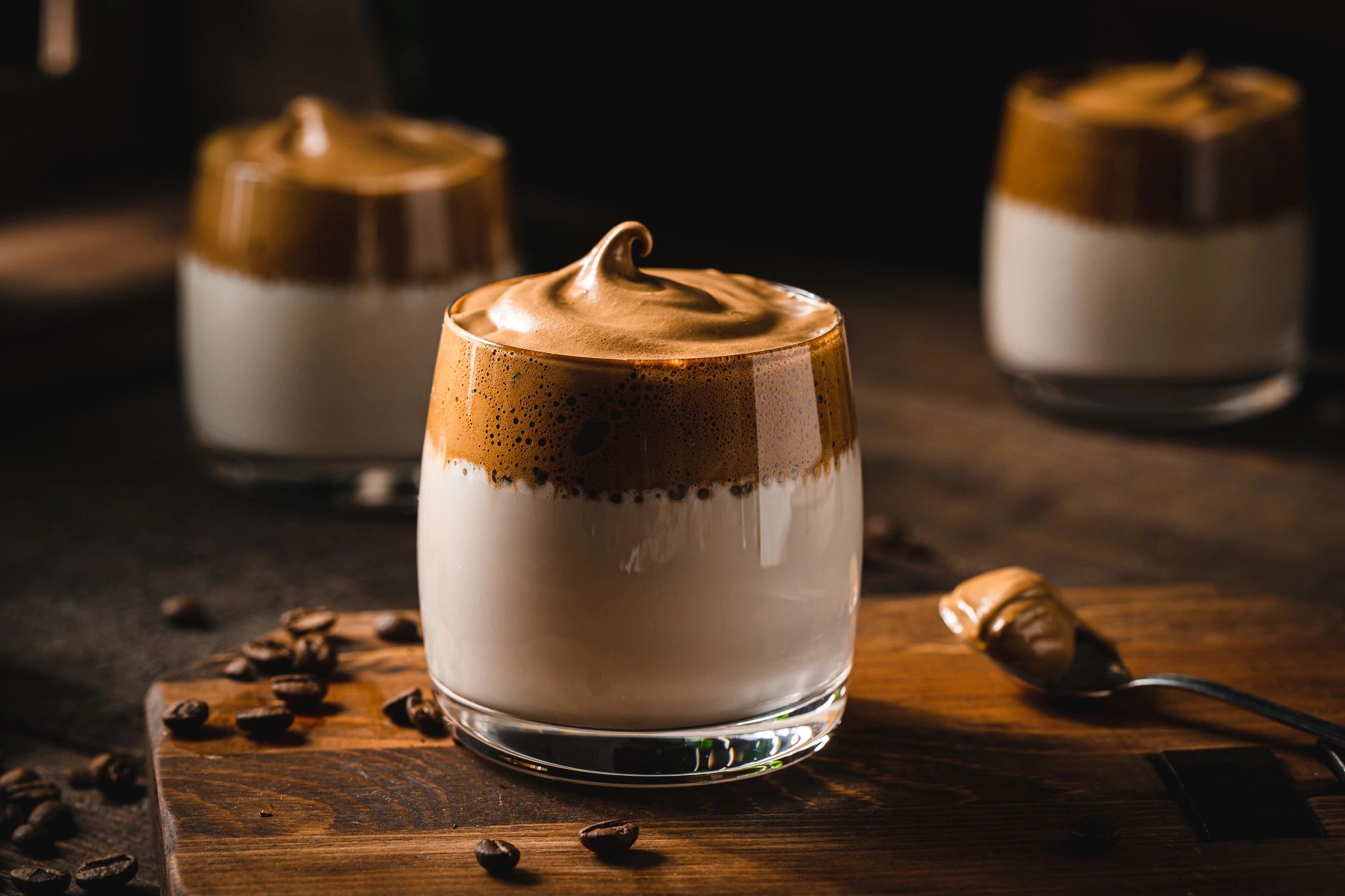 Cold coffee in a glass with creamy foam