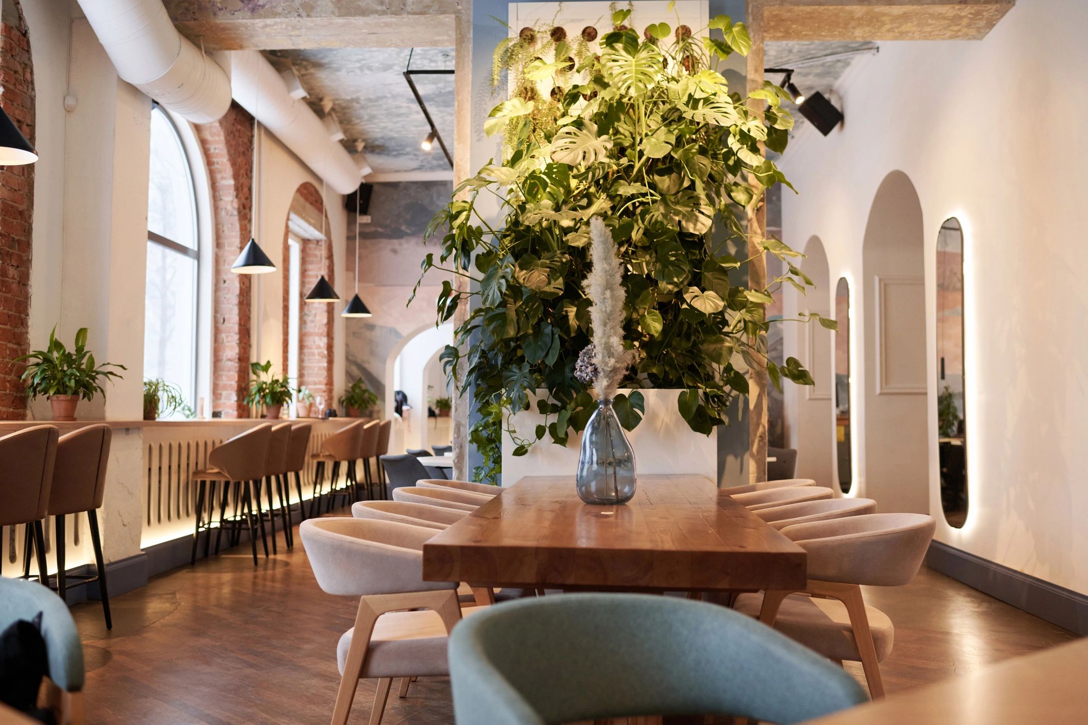 Modern dining interior with wooden furniture and plants