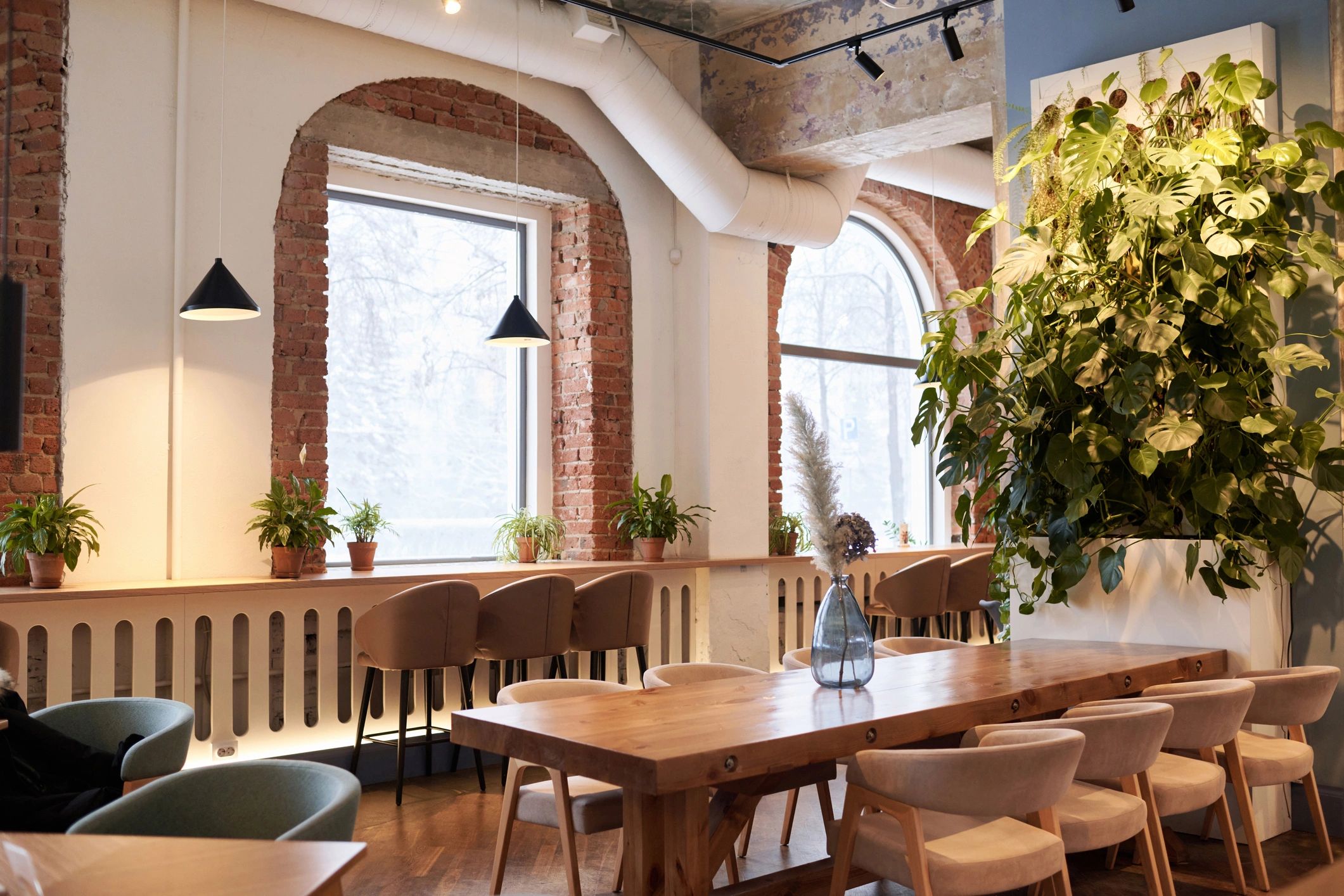Modern warm cafe interior with seating and plants