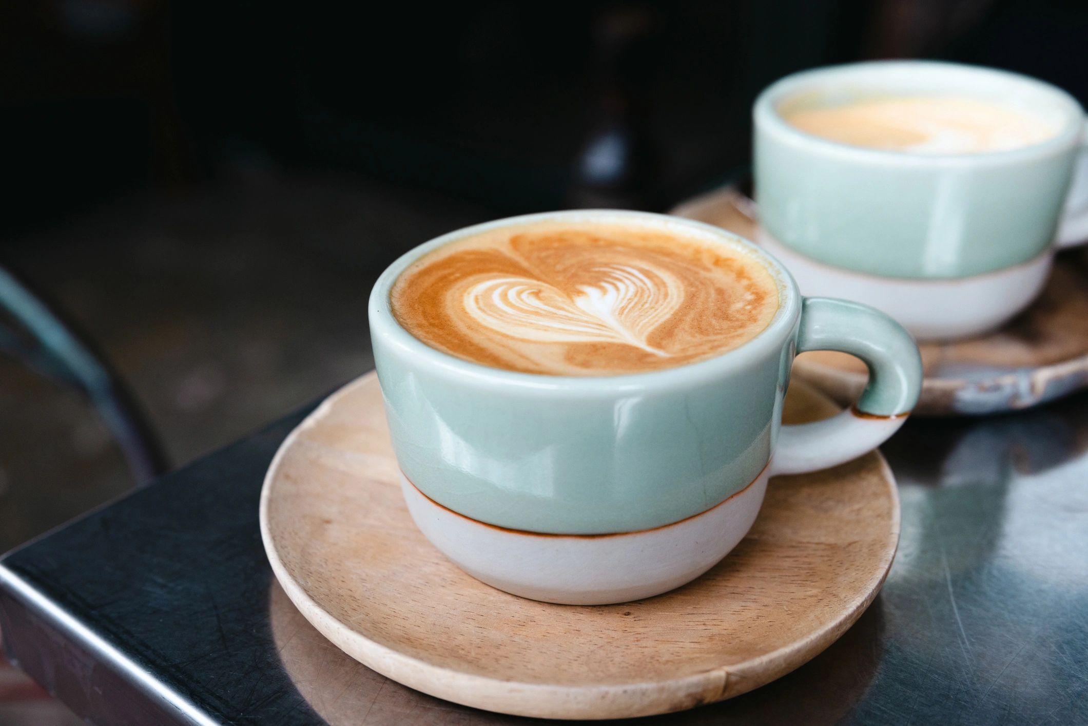 Cappuccino with latte art on a cafe table