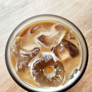 Top view Delicious Iced Coffee with Milk and Ice Cubes
